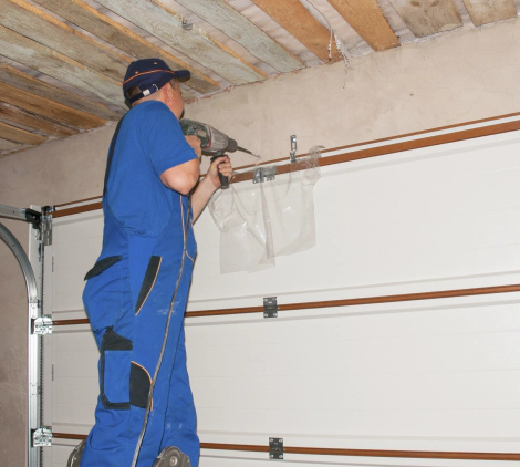 man installing insulated garage door